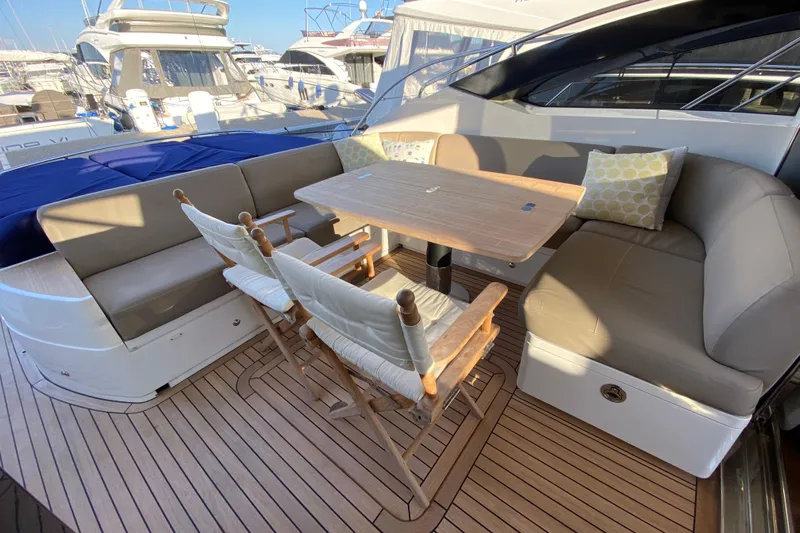 Aum Yacht Photos Pics Luxurious 2013 Princess V57 yacht deck with seating and dining area.
