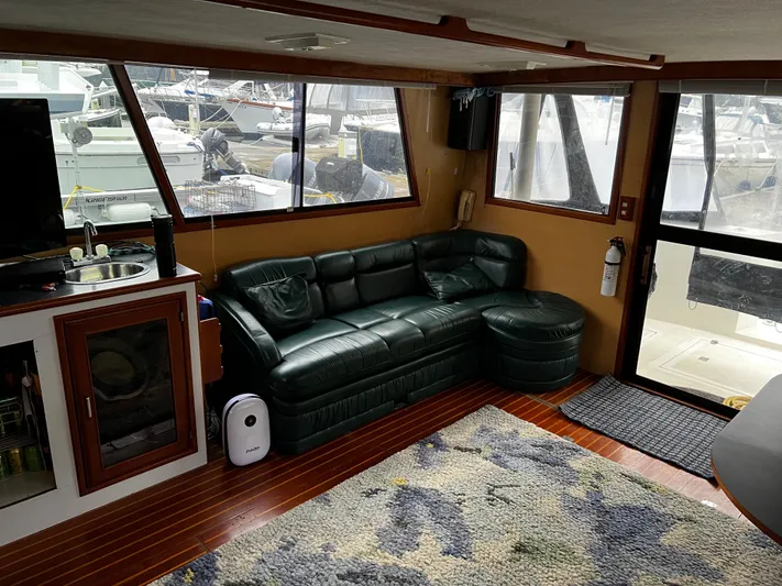 Paradosi Yacht Photos Pics Interior of a 1990 Nova 4500 boat with leather seating and kitchenette.