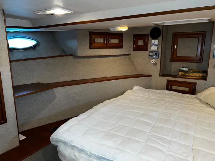 Paradosi Yacht Photos Pics Cozy cabin interior of 1990 Nova 4500 boat with bed and wooden accents.