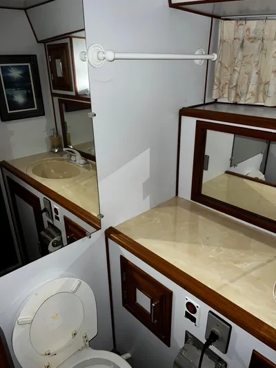 Paradosi Yacht Photos Pics 1990 Nova 4500 bathroom interior with sink, mirror, and toilet.