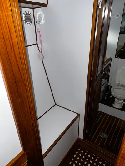 Paradosi Yacht Photos Pics Compact bathroom with wooden accents in a 1990 Nova 4500 model.