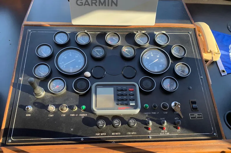 Paradosi Yacht Photos Pics Control panel of a 1990 Nova 4500 boat with gauges and Garmin device.