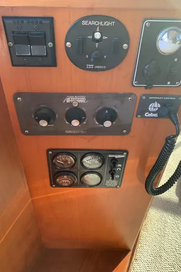 Paradosi Yacht Photos Pics Control panel of a 1990 Nova 4500 boat with searchlight and communication equipment.
