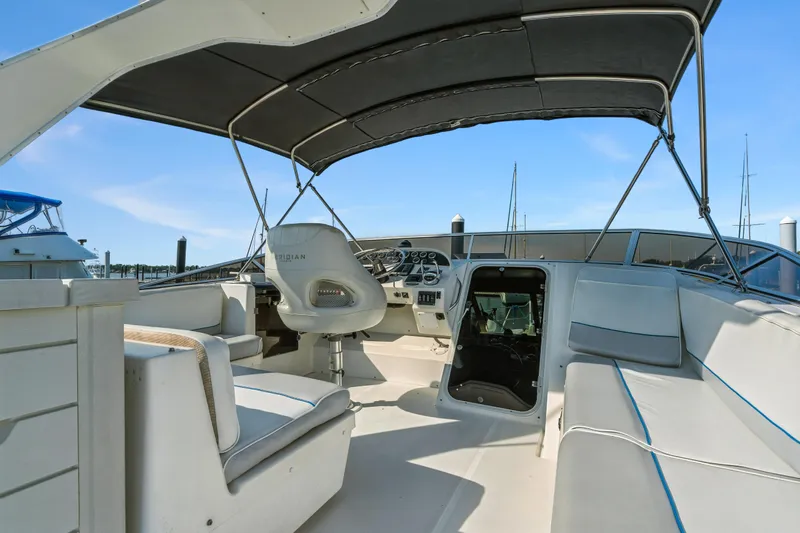 Trust Yacht Photos Pics 2007 Meridian 490 Pilothouse interior with helm, seating, and canopy in marina setting.