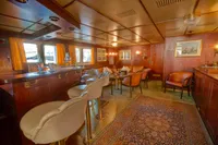 Luxurious 1982 Custom Husumer Shipyard interior with elegant seating and rich wood paneling.