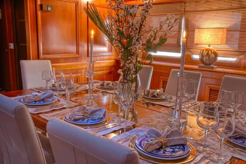 Sanssouci Star Yacht Photos Pics Luxurious dining setup on 1982 Custom Husumer Shipyard yacht, featuring elegant tableware and decor.