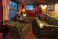 Luxurious ship interior with leather seating, warm lighting, and elegant decor, Husumer Shipyard, 1982.