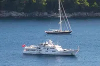 Two boats on calm water, featuring a 1982 Custom Husumer Shipyard yacht.