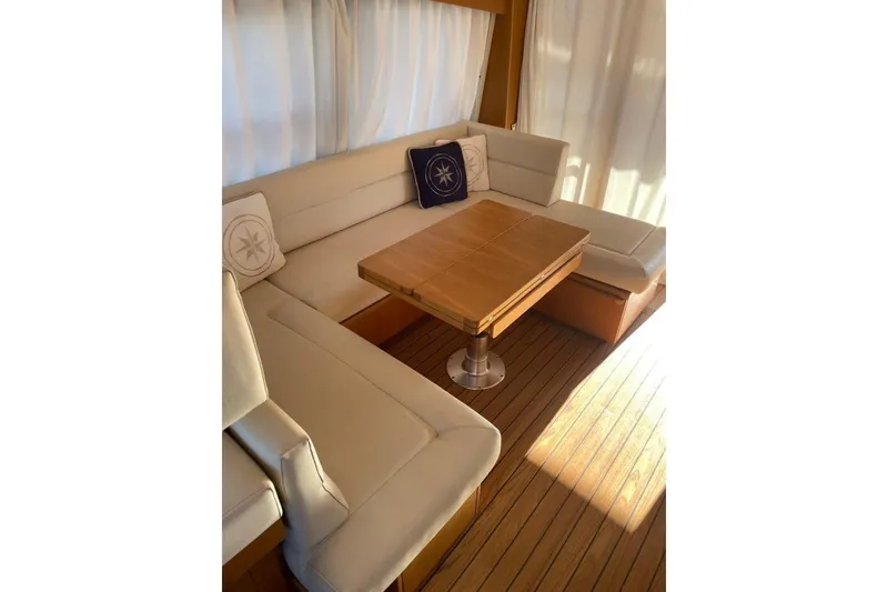  Yacht Photos Pics Luxurious interior of 2007 Apreamare 48 yacht with elegant seating and wooden table.