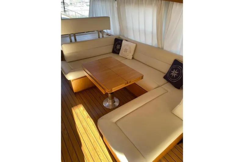  Yacht Photos Pics Luxurious seating area on 2007 Apreamare 48 yacht with wooden table and cushions.