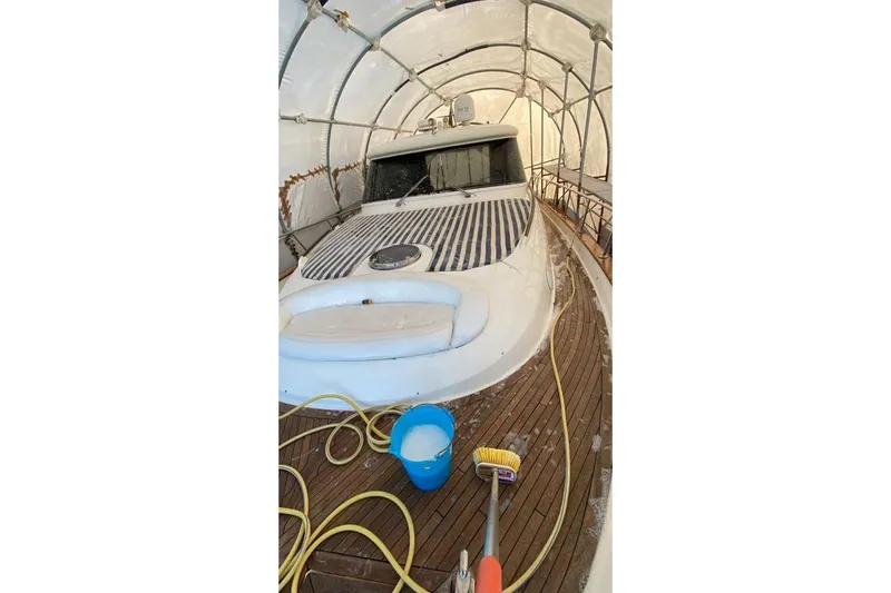  Yacht Photos Pics 2007 Apreamare 48 yacht in storage, wooden deck, cleaning supplies visible.