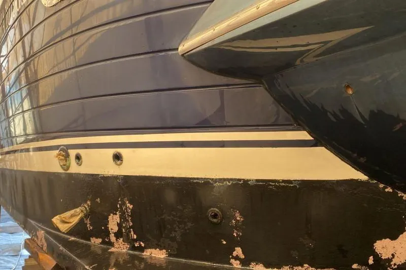  Yacht Photos Pics Close-up of 2007 Apreamare 48 boat hull with visible wear and peeling paint.