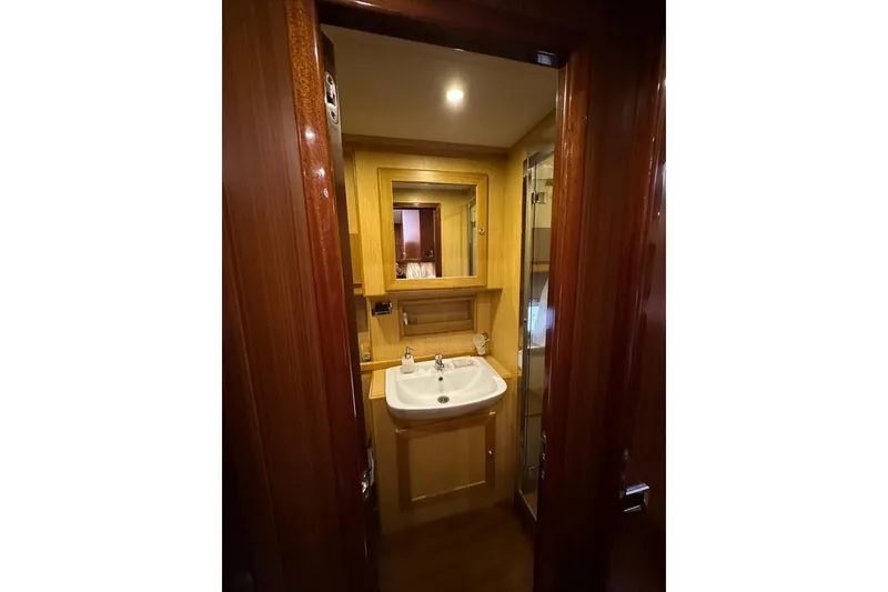  Yacht Photos Pics Luxurious bathroom interior of 2007 Apreamare 48 yacht with wooden finish and modern fixtures.