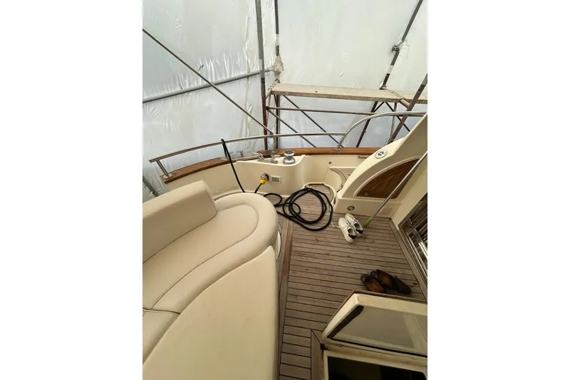  Yacht Photos Pics 2007 Apreamare 48 yacht deck with seating, wooden flooring, and nautical equipment.