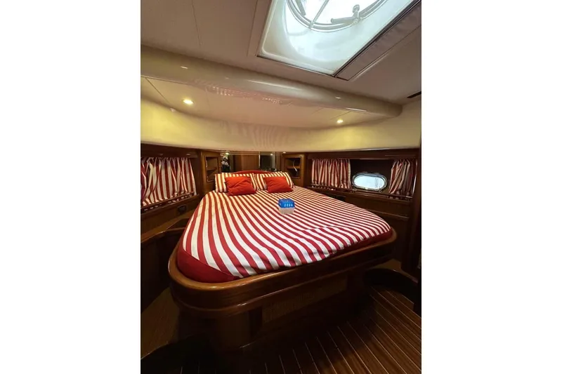  Yacht Photos Pics Luxurious cabin interior of 2007 Apreamare 48 yacht with striped bedding.