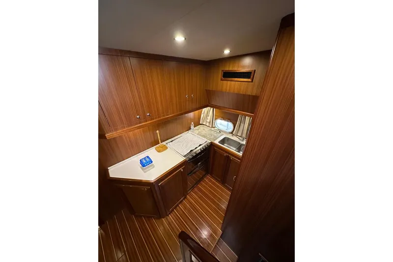  Yacht Photos Pics Luxurious wooden interior of 2007 Apreamare 48 yacht kitchen with modern amenities.