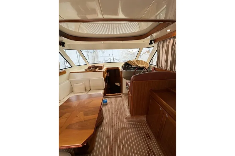  Yacht Photos Pics Interior of 2007 Apreamare 48 yacht with elegant wood finishes and seating area.