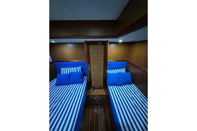  Yacht Photos Pics Interior of 2007 Apreamare 48 yacht with twin beds and striped bedding.