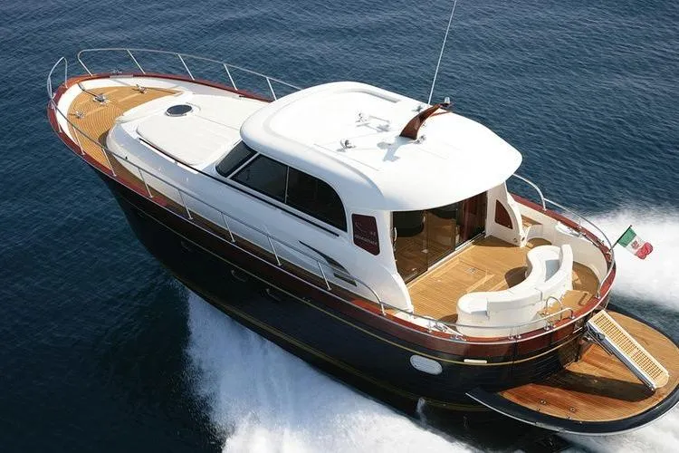  Yacht Photos Pics 2007 Apreamare 48 yacht cruising on open water, showcasing elegant design and craftsmanship.