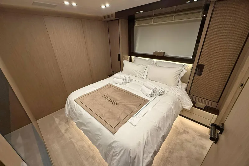 Ship Happens Yacht Photos Pics Luxurious bedroom interior of 2024 Maiora 30 Walkaround yacht with elegant bedding.