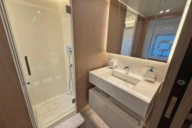 Ship Happens Yacht Photos Pics Luxurious bathroom in 2024 Maiora 30 Walkaround yacht with modern fixtures and elegant design.