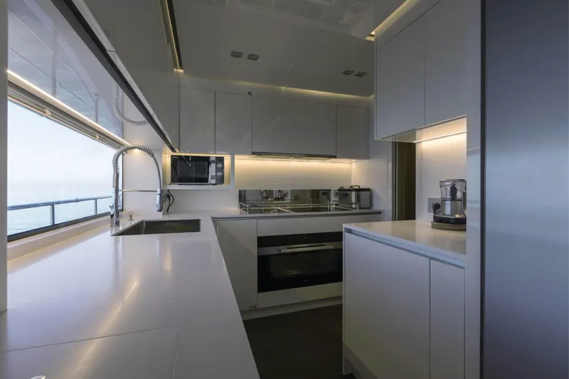 Ship Happens Yacht Photos Pics Luxurious kitchen interior of 2024 Maiora 30 Walkaround yacht with modern appliances.