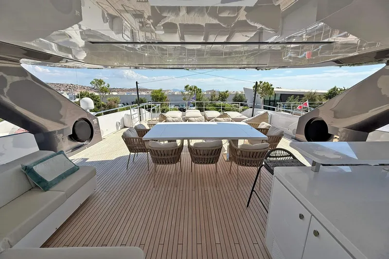 Ship Happens Yacht Photos Pics Luxurious 2024 Maiora 30 Walkaround yacht deck with elegant seating and dining area.