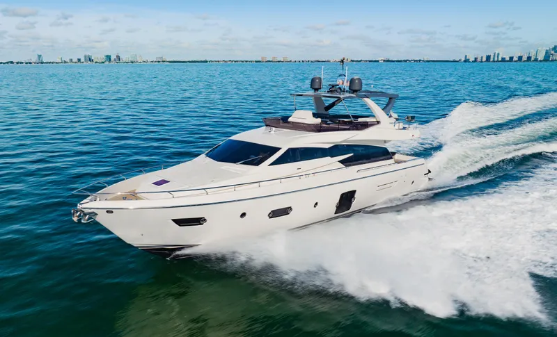 Sami Kay III Yacht Photos Pics Luxurious 2017 Ferretti Yachts 750 cruising on open water, city skyline in background.