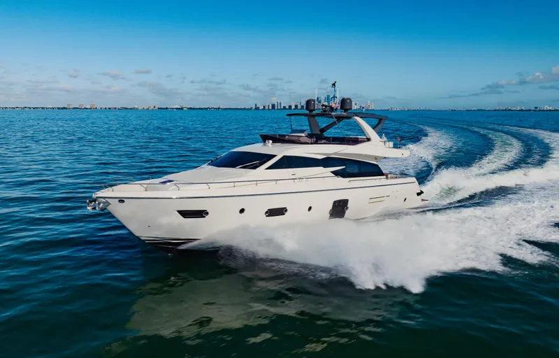 Sami Kay III Yacht Photos Pics 2017 Ferretti Yachts 750 cruising on open water with city skyline in background.