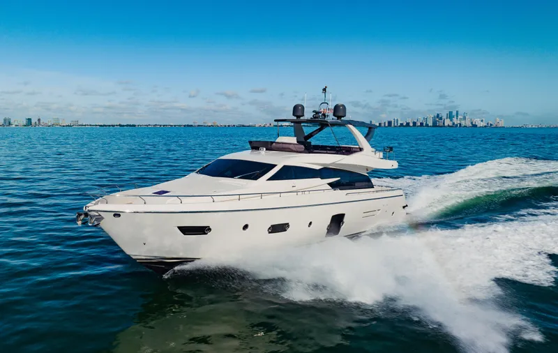 Sami Kay III Yacht Photos Pics 2017 Ferretti Yachts 750 cruising on open water with city skyline in background.