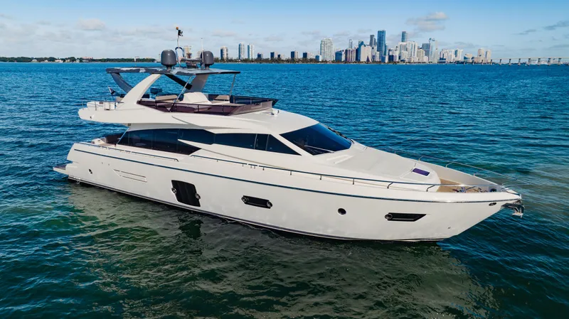 Sami Kay III Yacht Photos Pics Luxury 2017 Ferretti Yachts 750 cruising near city skyline on a sunny day.