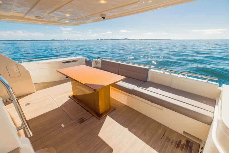 Sami Kay III Yacht Photos Pics Luxurious 2017 Ferretti Yachts 750 deck with seating and table, overlooking serene ocean view.