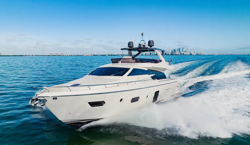 Sami Kay III Yacht Photos Pics 2017 Ferretti Yachts 750 cruising on open water with city skyline in background.