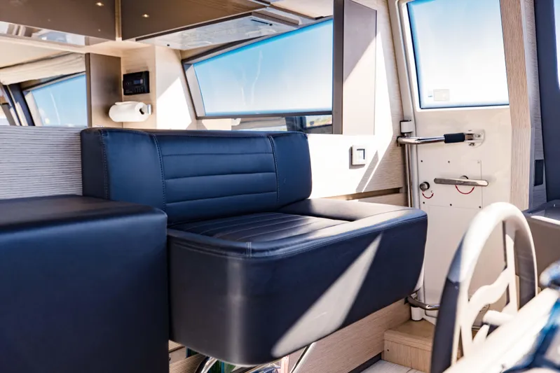 Sami Kay III Yacht Photos Pics Interior of 2017 Ferretti Yachts 750, featuring sleek black seating and modern design elements.