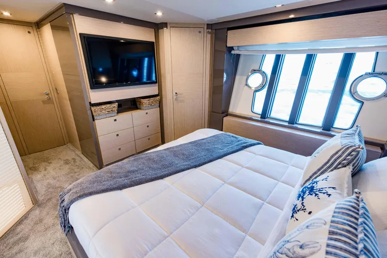 Sami Kay III Yacht Photos Pics Luxurious bedroom interior of 2017 Ferretti Yachts 750 with modern decor and large windows.