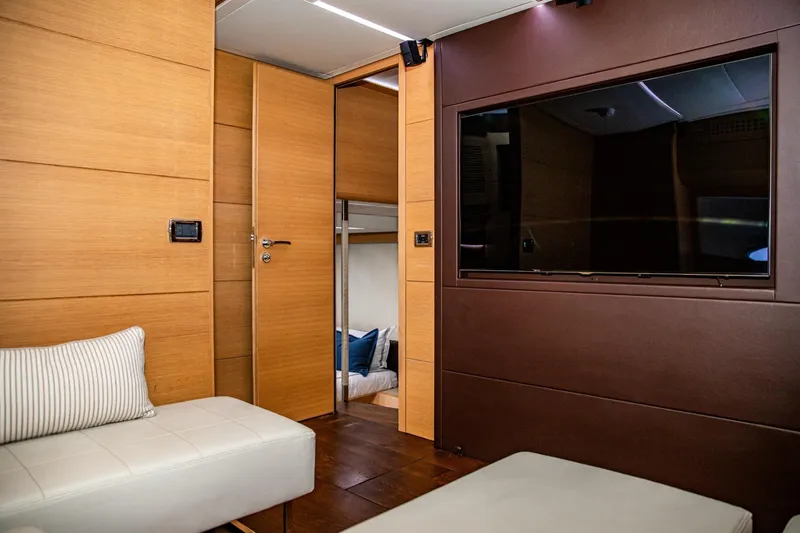 Dorothy Ann Yacht Photos Pics Luxurious interior of 2012 Pershing Sport Boat, featuring modern wood paneling and a large TV.