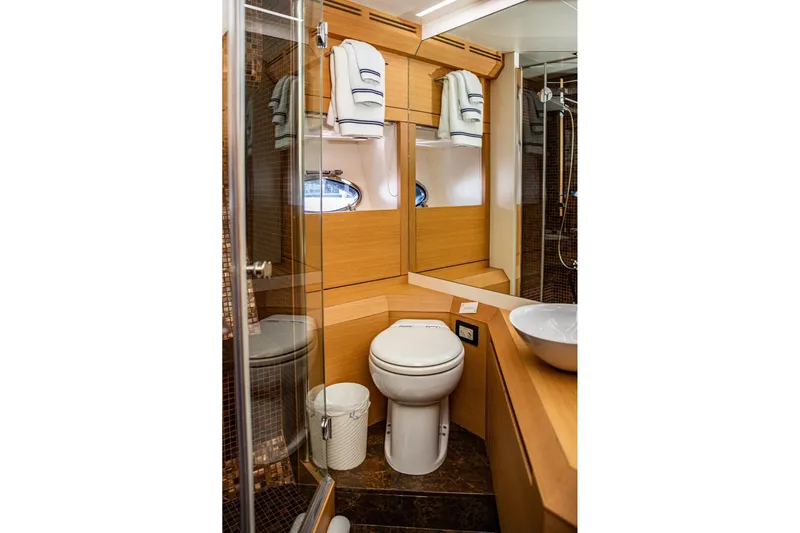 Dorothy Ann Yacht Photos Pics Luxurious bathroom in 2012 Pershing Sport Boat, featuring modern fixtures and wooden accents.