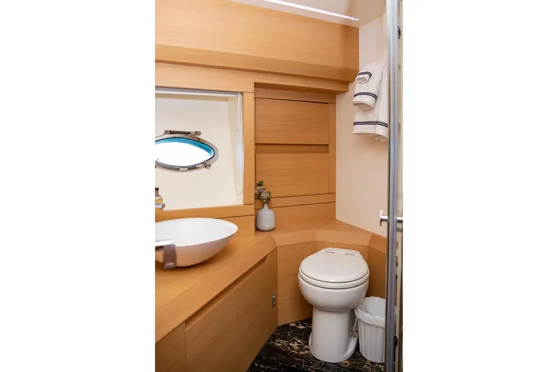 Dorothy Ann Yacht Photos Pics Luxurious bathroom in 2012 Pershing Sport Boat, featuring modern fixtures and elegant wood finishes.