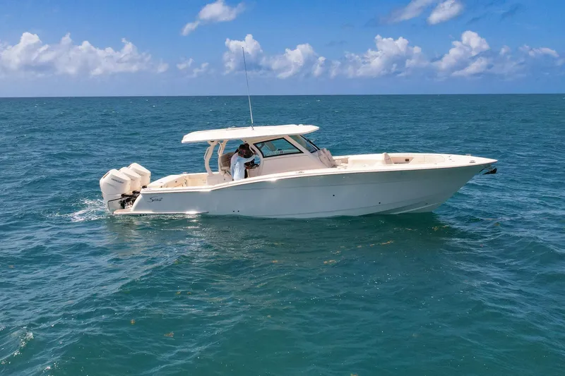  Yacht Photos Pics 2024 Scout 377 LXF boat cruising on open ocean under clear blue sky.