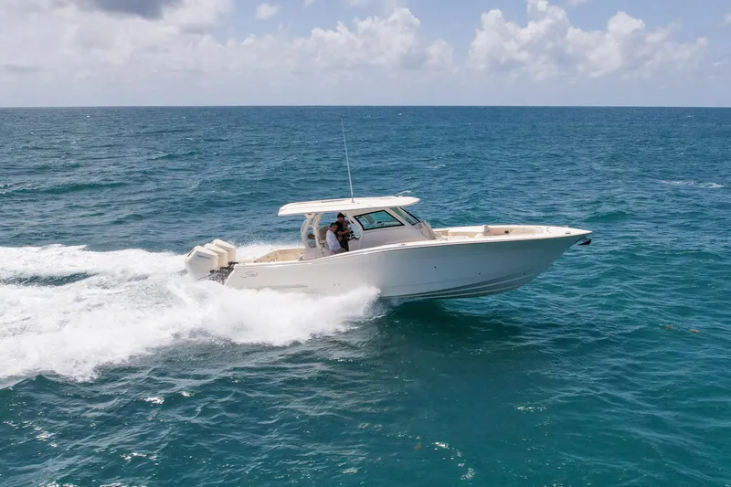  Yacht Photos Pics 2024 Scout 377 LXF boat cruising on open ocean under clear skies.