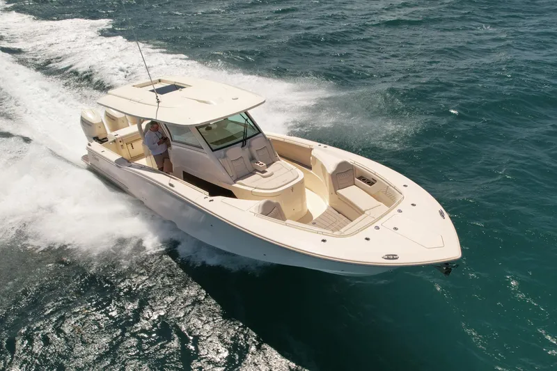  Yacht Photos Pics 2024 Scout 377 LXF boat cruising on open water, showcasing sleek design and powerful performance.
