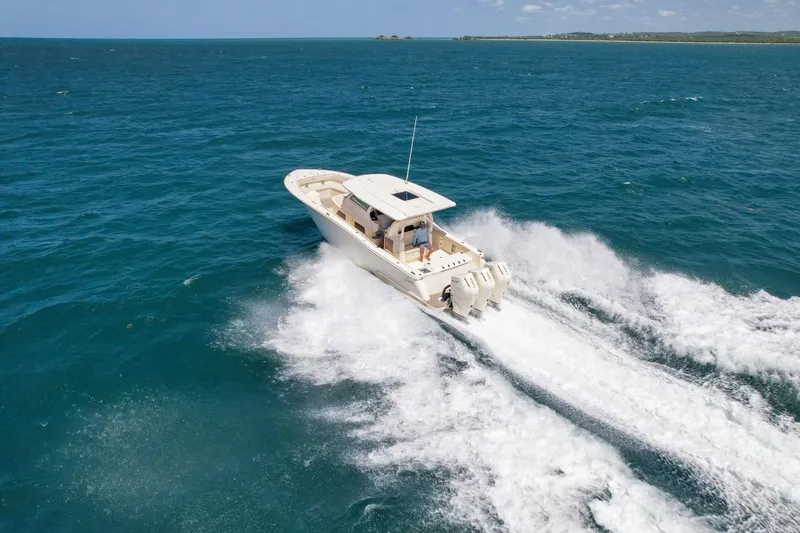  Yacht Photos Pics 2024 Scout 377 LXF boat cruising on open ocean waters.