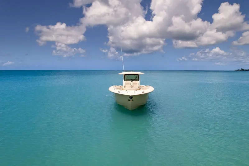  Yacht Photos Pics 2024 Scout 377 LXF boat on tranquil turquoise sea under cloudy sky.