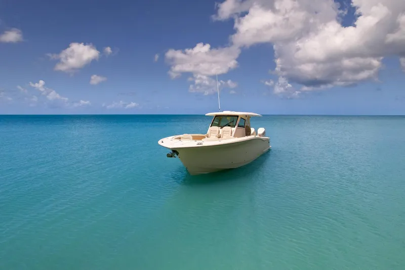  Yacht Photos Pics 2024 Scout 377 LXF boat on tranquil turquoise sea under blue sky.