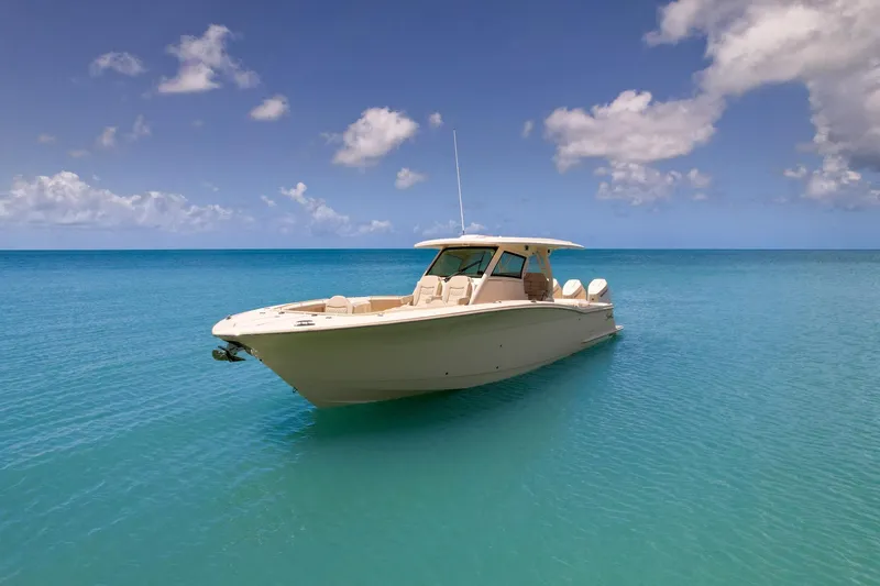  Yacht Photos Pics 2024 Scout 377 LXF boat on clear blue ocean under a partly cloudy sky.