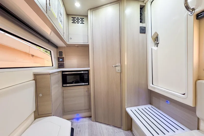 Yacht Photos Pics 2024 Scout 377 LXF interior with modern cabinetry, microwave, and sleek design.