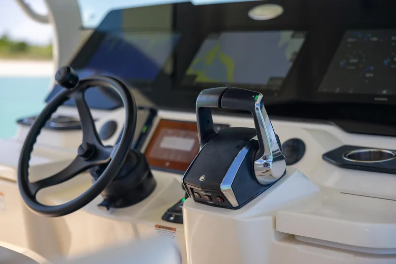  Yacht Photos Pics 2024 Scout 377 LXF boat helm with steering wheel and control panel.