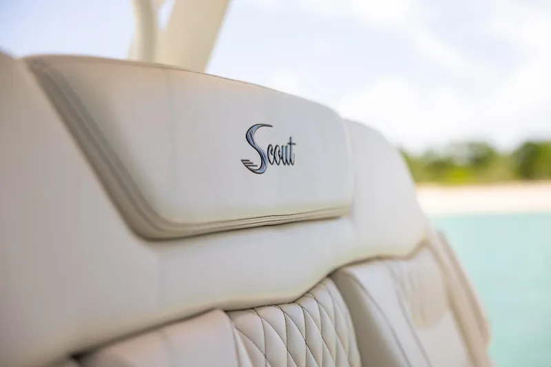  Yacht Photos Pics 2024 Scout 377 LXF boat seat with logo, featuring luxurious beige upholstery.