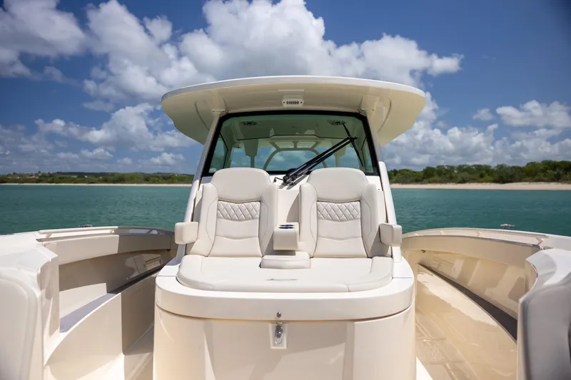  Yacht Photos Pics 2024 Scout 377 LXF boat interior with luxurious seating, ocean view, and clear sky.