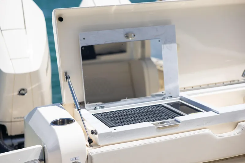  Yacht Photos Pics 2024 Scout 377 LXF boat grill station with open lid, showcasing sleek design.
